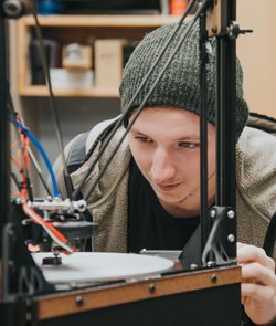 Male Engineering Student in Robotics Lab