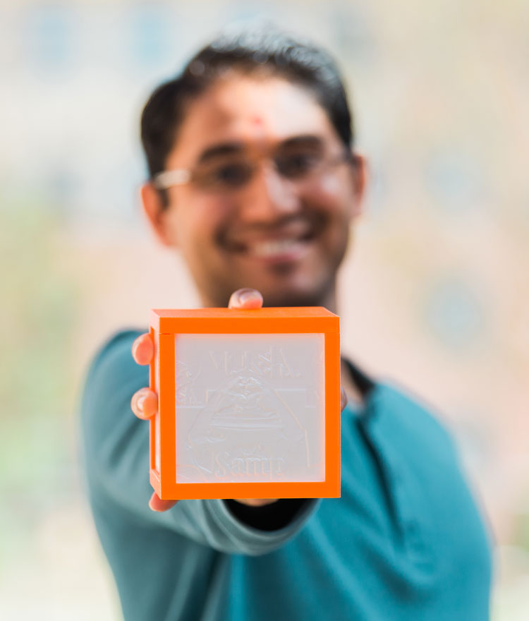 Mercer Engineering Student holding out an orange square