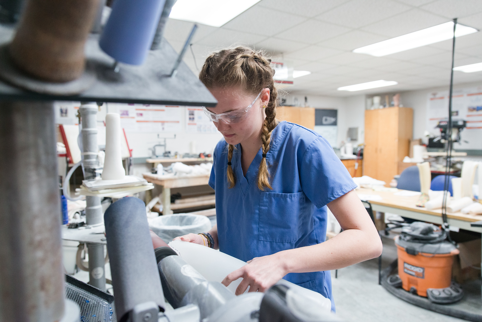 Mercer University student in engineering lab working with prosthetic