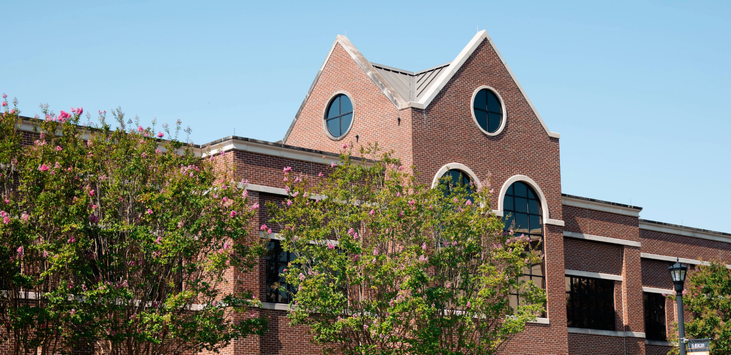Science and Engineering building with trees blooming with pink flowers in front